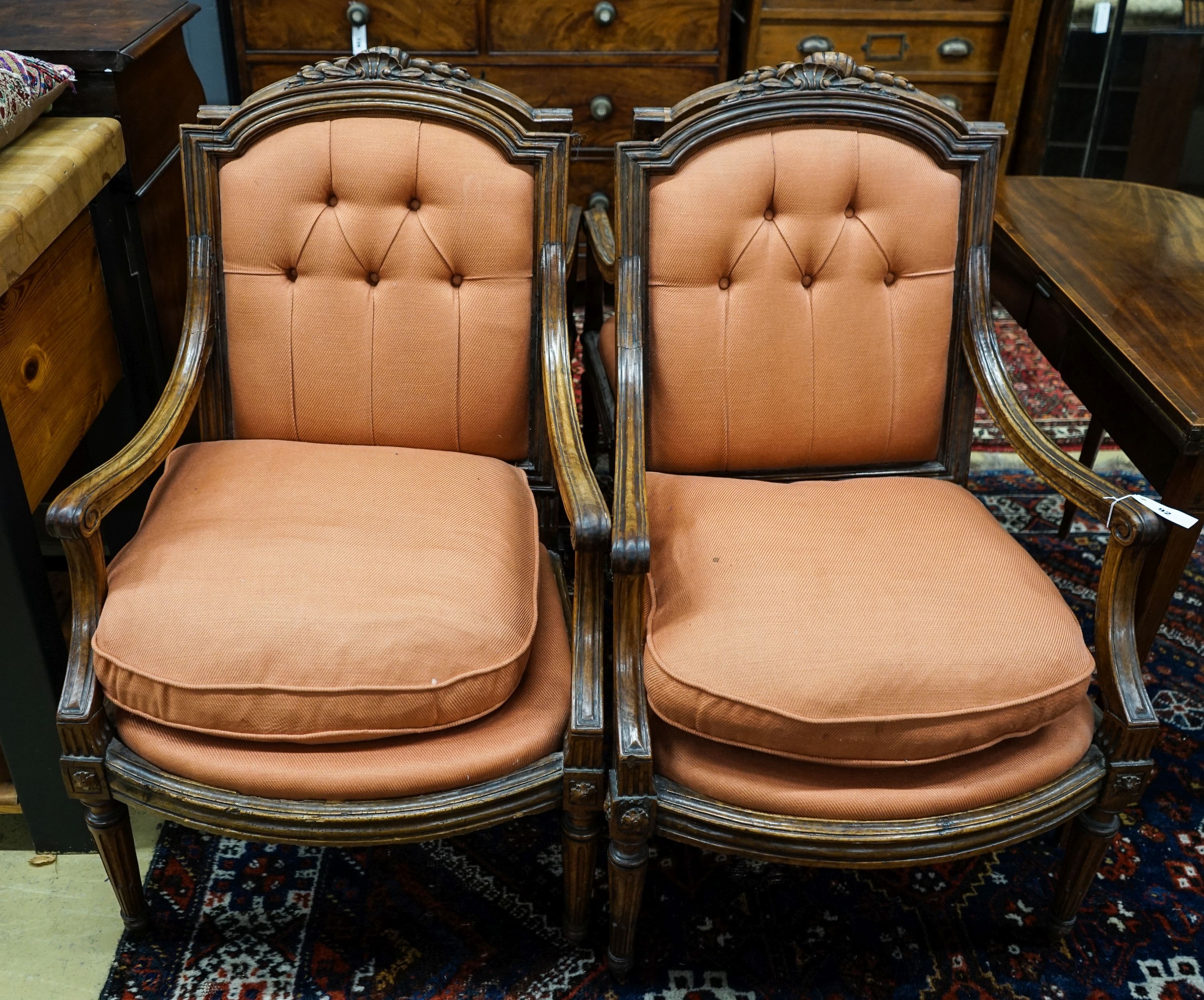 A set of four 19th century French carved walnut elbow chairs with buttoned fabric upholstery, width 65cm, depth 52cm, height 96cm                                                                                           