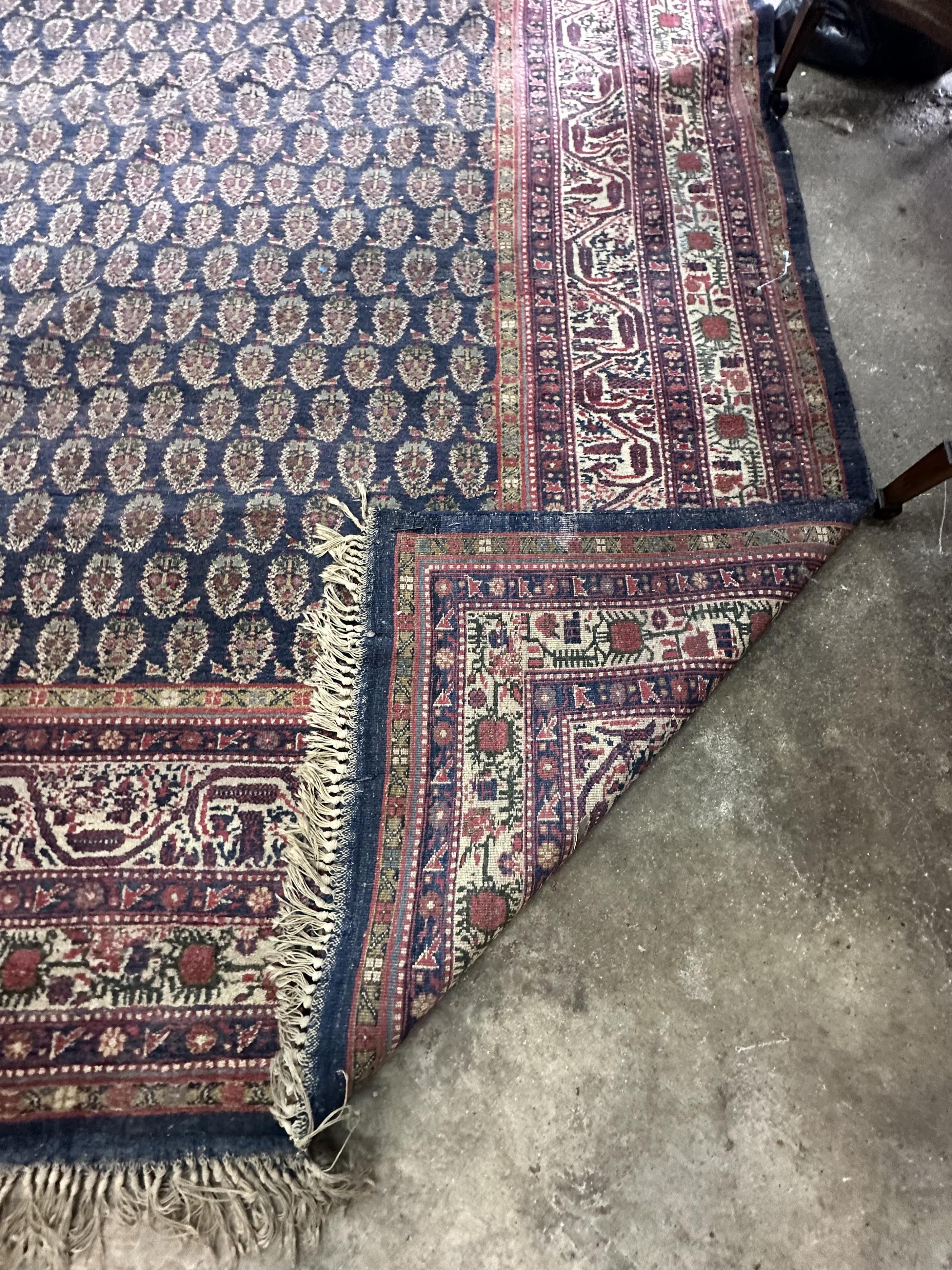 A Serabend blue ground boteh carpet, approximately 406 x 334cm. Condition - poor                                                                                                                                            