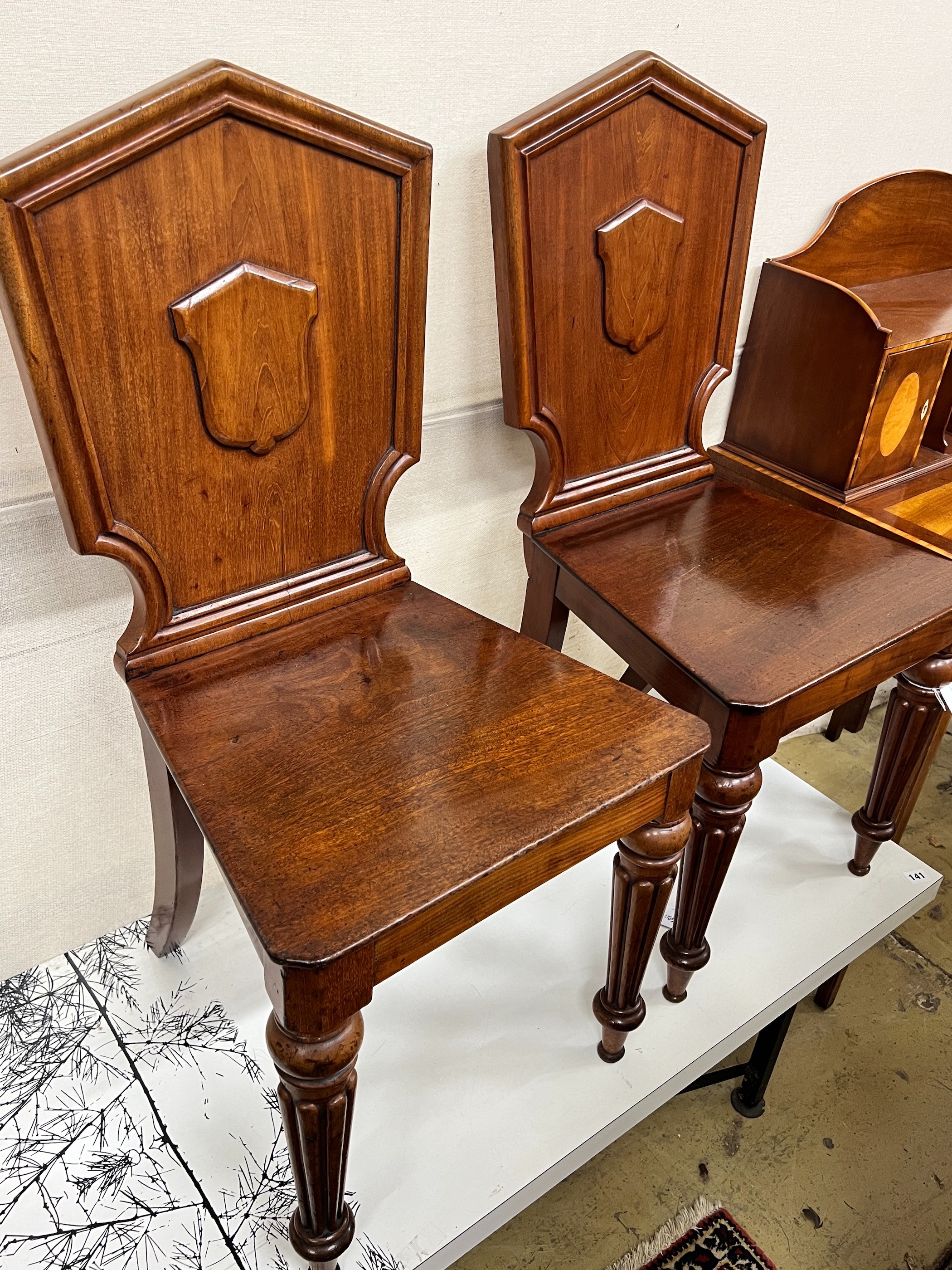 A pair of Victorian mahogany hall chairs                                                                                                                                                                                    
