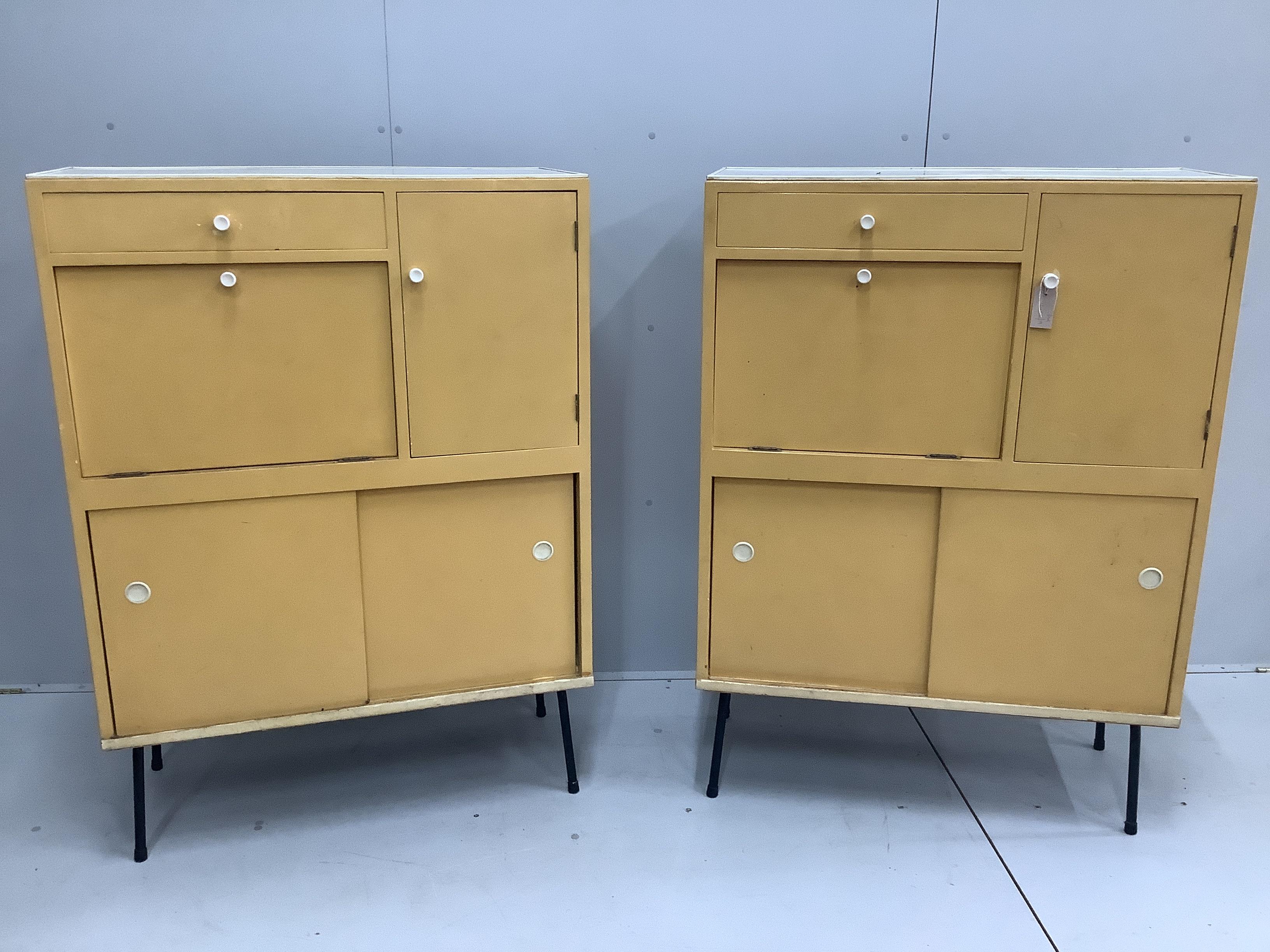 A pair of 1960's melamine household cabinets, each width 91cm, depth 41cm, height 127cm                                                                                                                                     