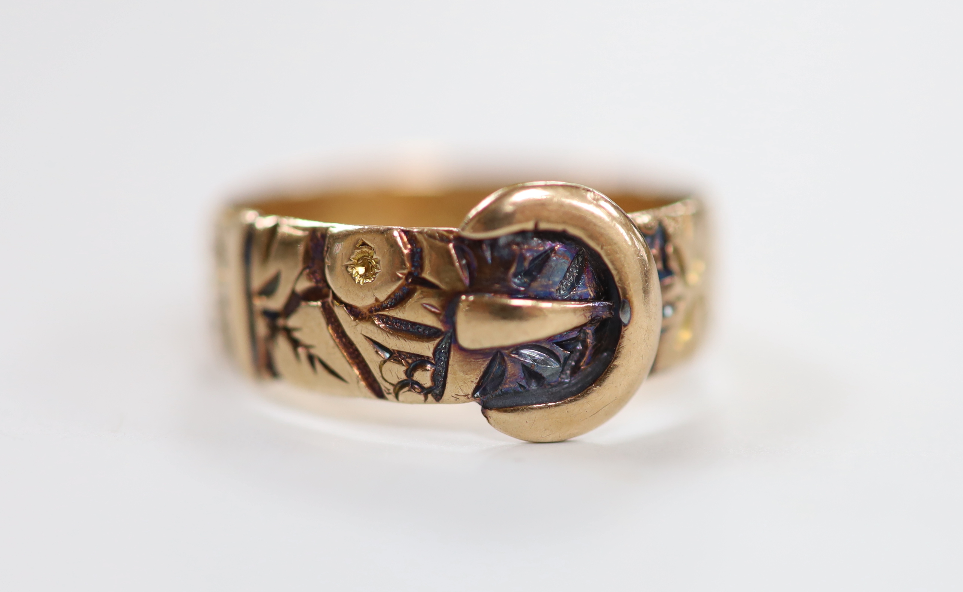 A George V 9ct gold buckle ring, Birmingham, 1915, size O, 3.1 grams.                                                                                                                                                       