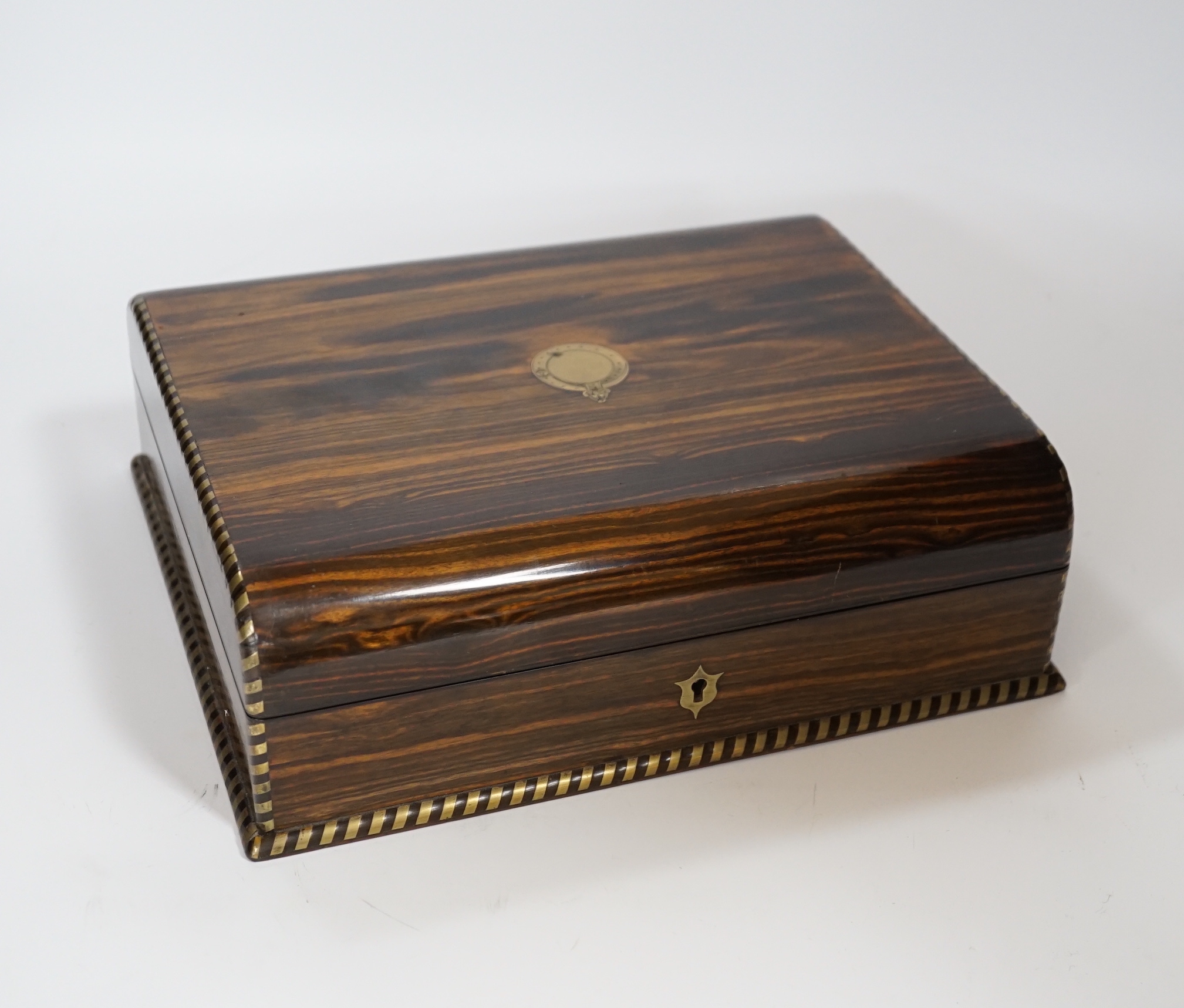 A Victorian coromandel wood stationary box with brass mounted edging, engraved maker or retailers label ‘BB Wells, Cutler, Strand and city’, 27cm wide                                                                      