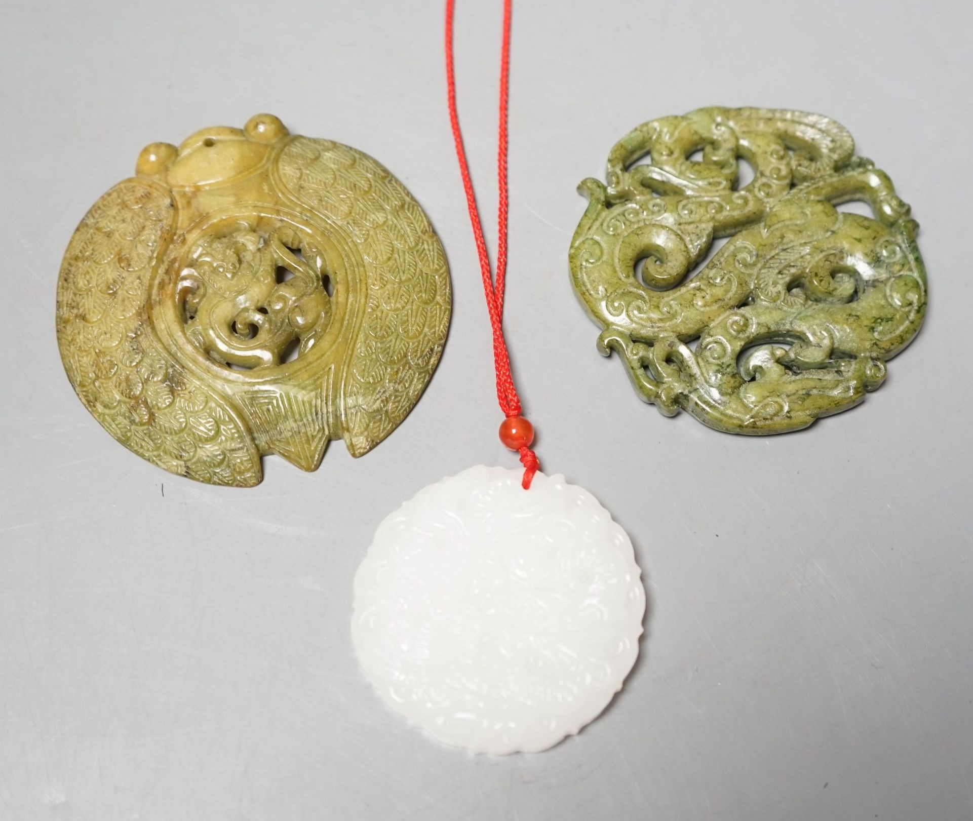 Three Chinese carved jade or hardstone pendants                                                                                                                                                                             