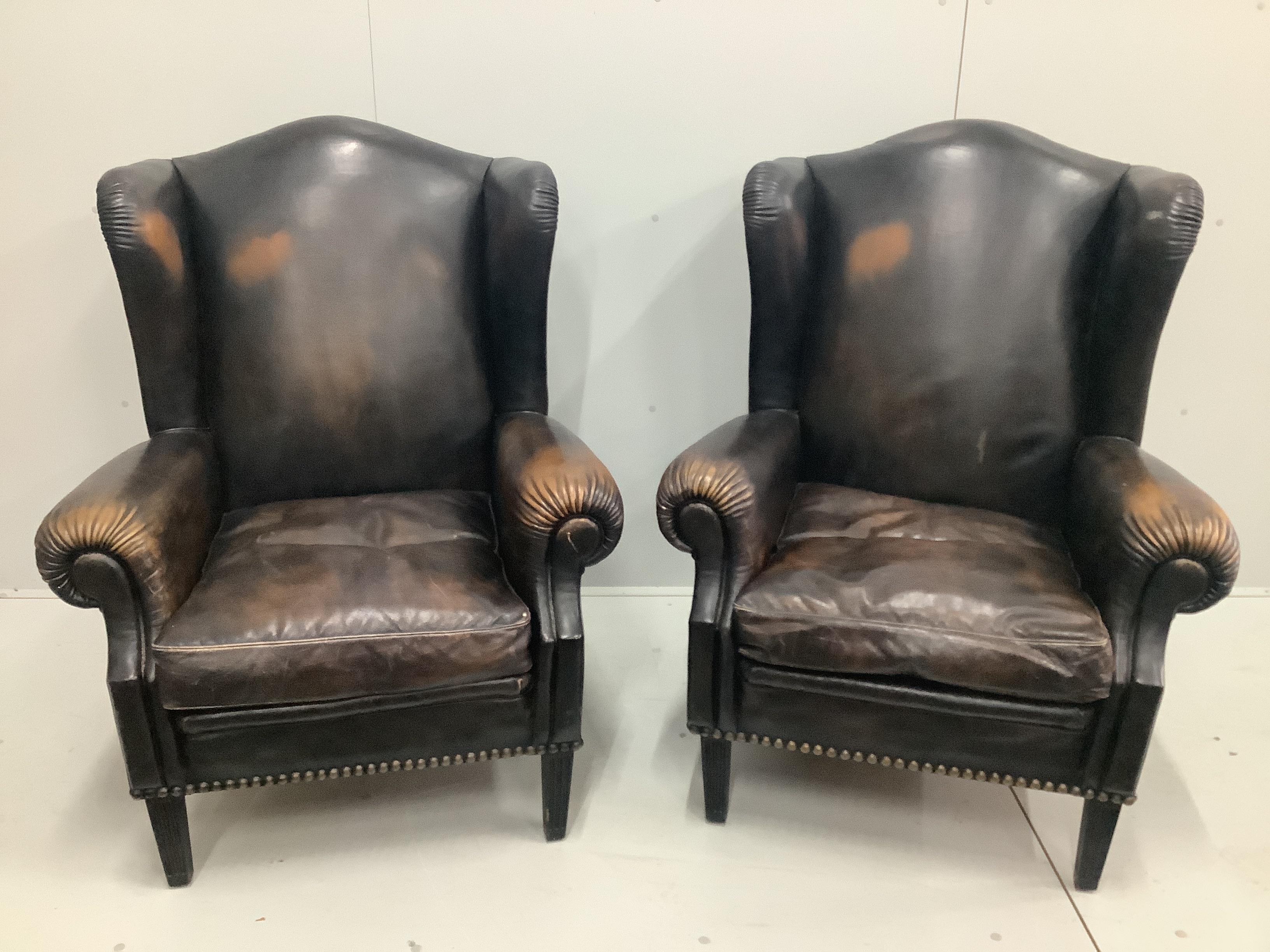 A pair of Victorian style brown leather wing armchairs, width 78cm, depth 88cm, height 106cm                                                                                                                                