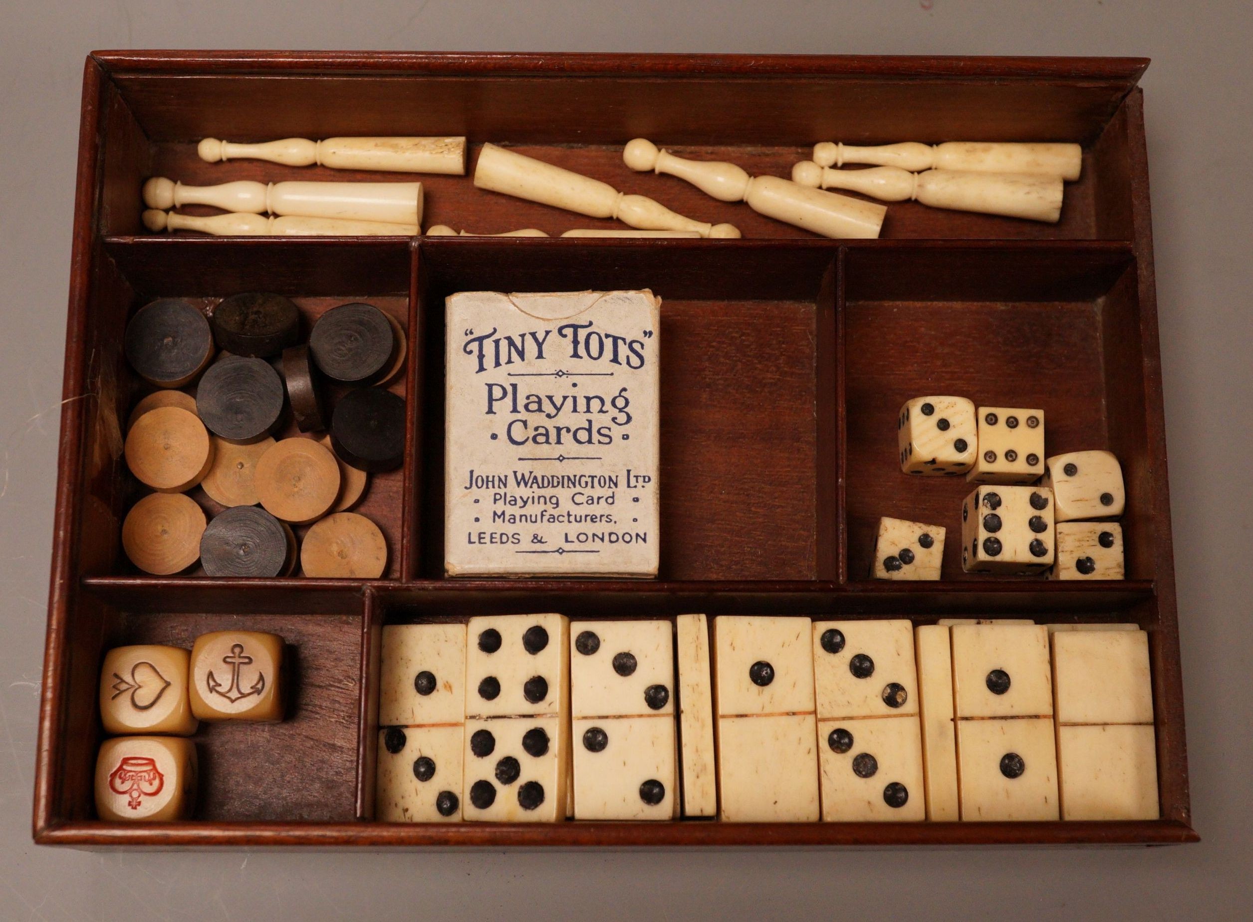 A miniature 19th century games compendium with carved bone playing pieces                                                                                                                                                   