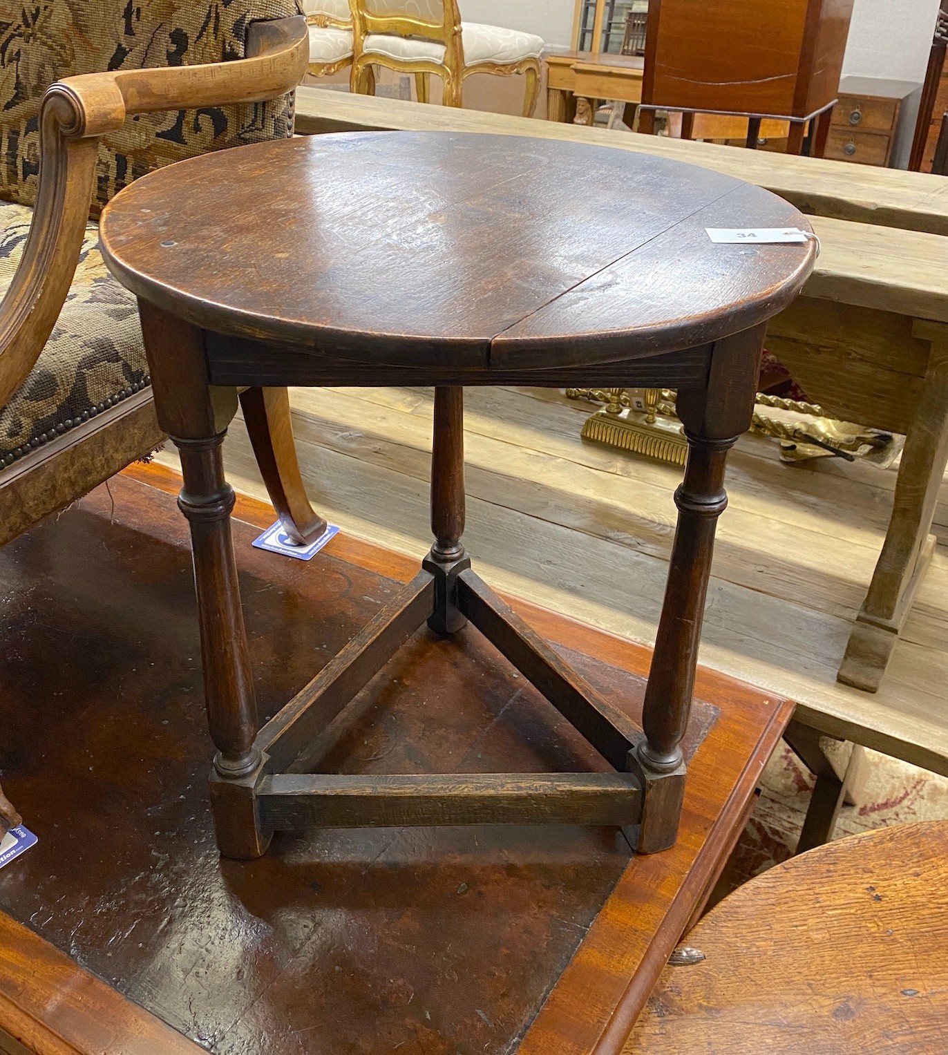 An early 20th century oak cricket table, diameter 55cm, height 61cm                                                                                                                                                         