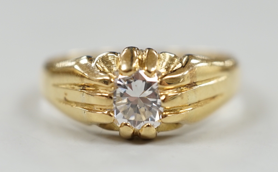 An 18ct and claw set solitaire diamond ring, size W/X, gross weight 7.3 grams.                                                                                                                                              