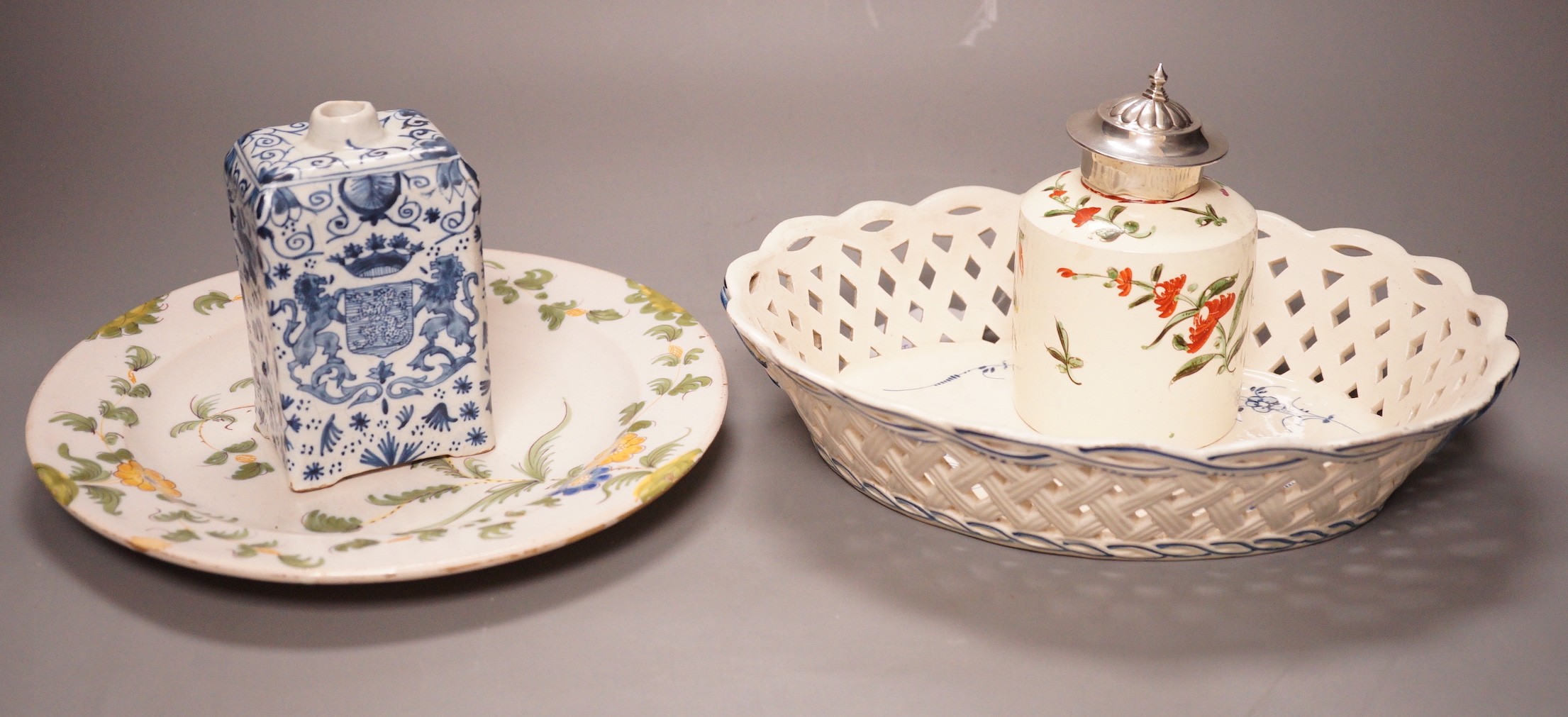 A Leeds creamware jar, a Delft armorial caddy, a Cantagalli maiolica plate and a creamware chestnut basket                                                                                                                  