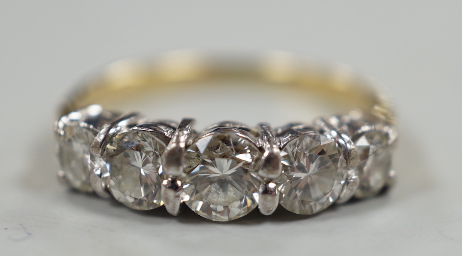 A gold and graduated five stone diamond set half hoop ring, size G/H, gross weight 2.7 grams.                                                                                                                               