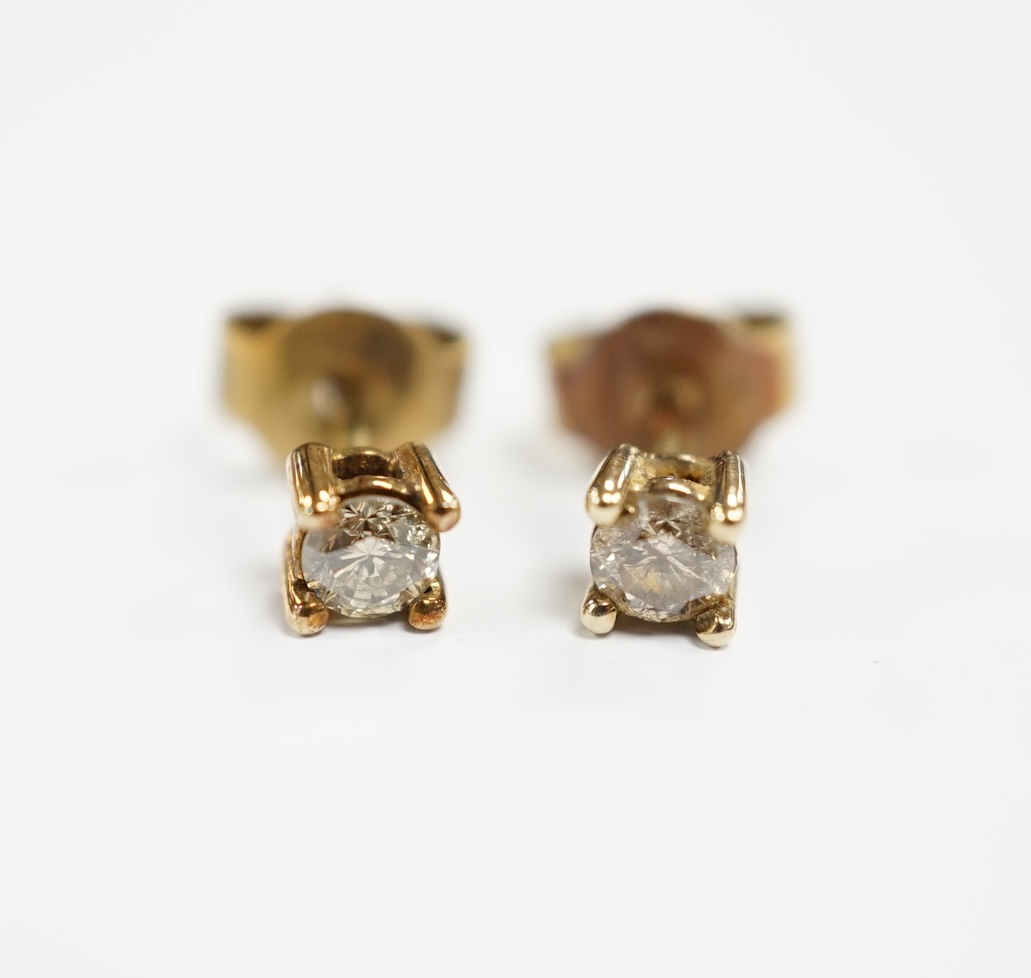 A small pair of 375 and solitaire diamond set ear studs, gross weight 0.8 grams.                                                                                                                                            