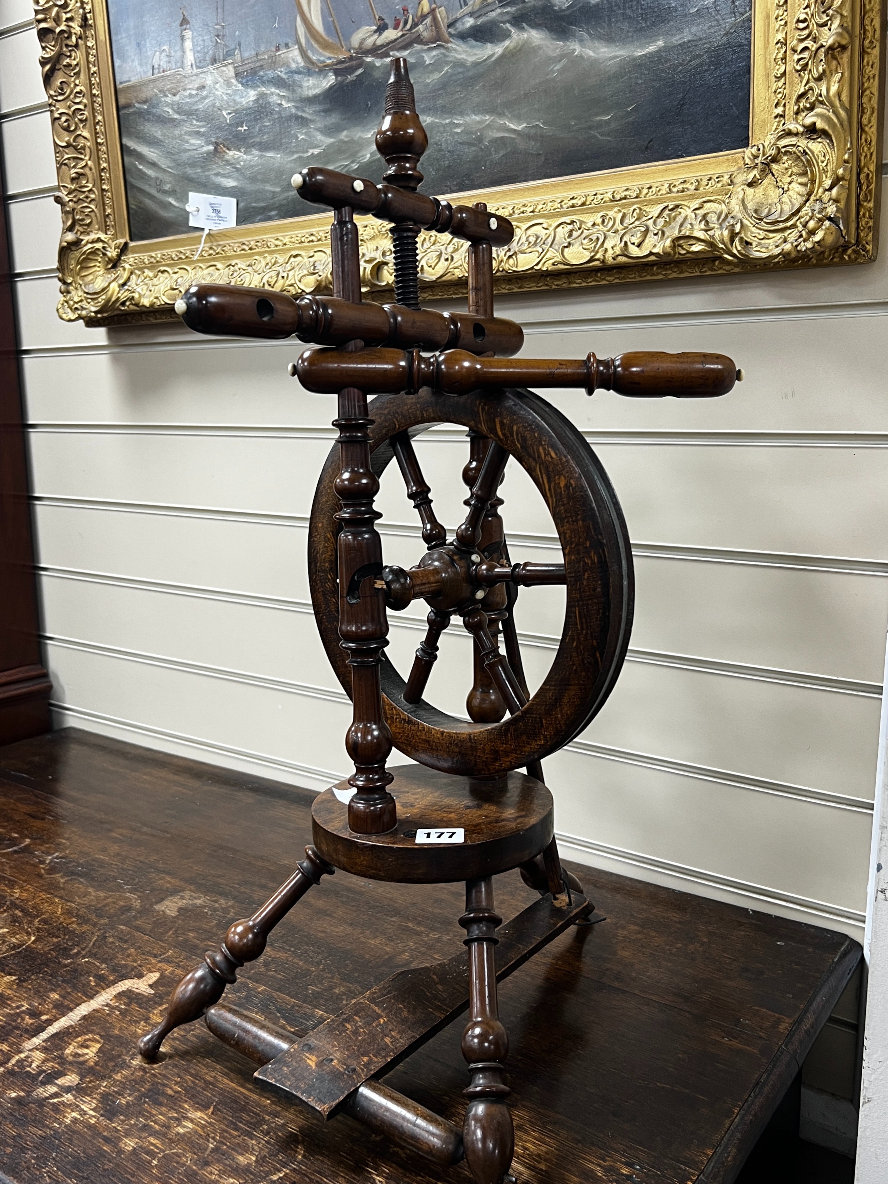 A provincial mahogany and beech spinning wheel, height 67cm                                                                                                                                                                 