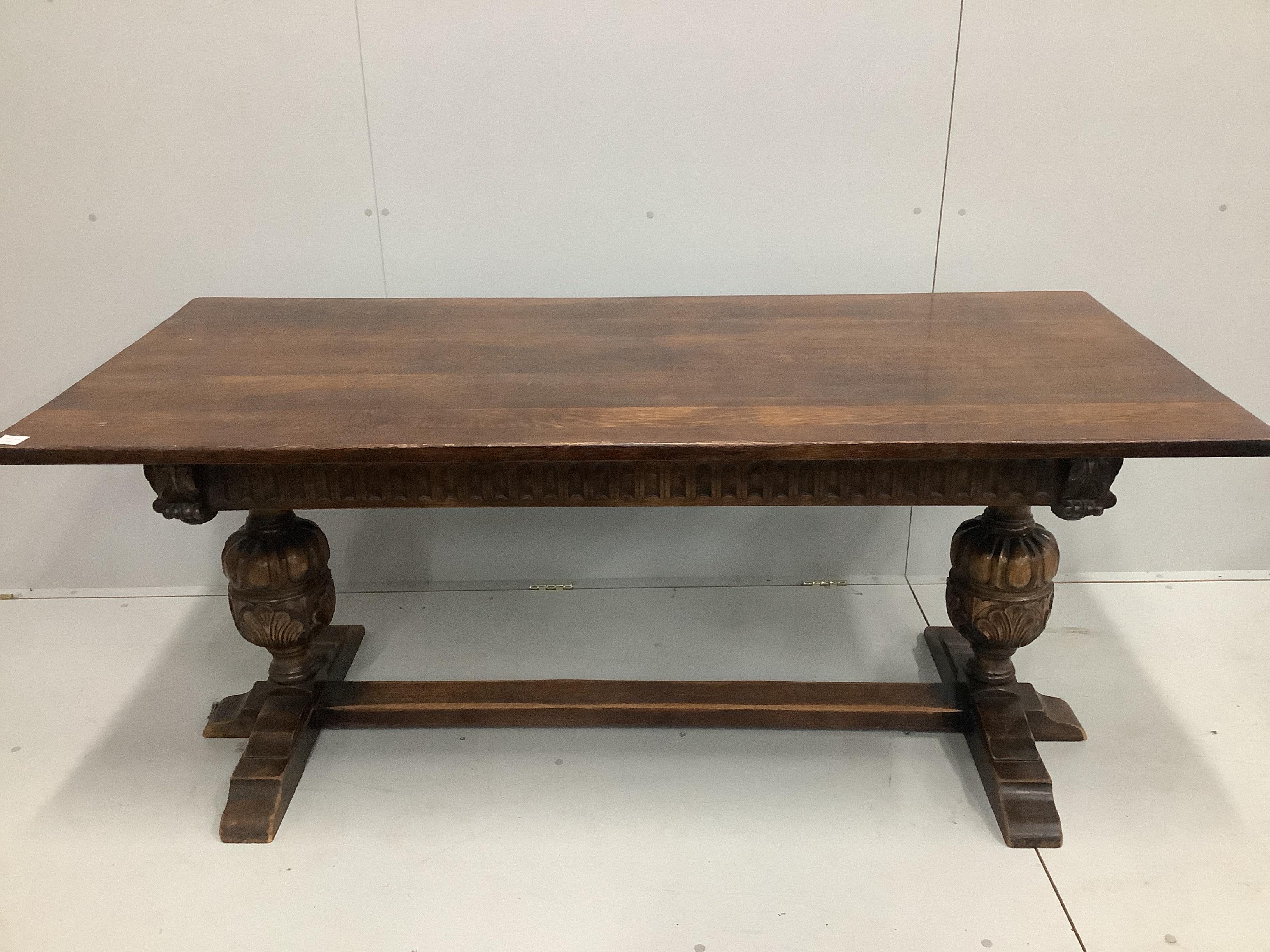 An 18th century style rectangular oak refectory dining table, width 183cm, depth 83cm, height 77cm and eight studded leather chairs                                                                                         