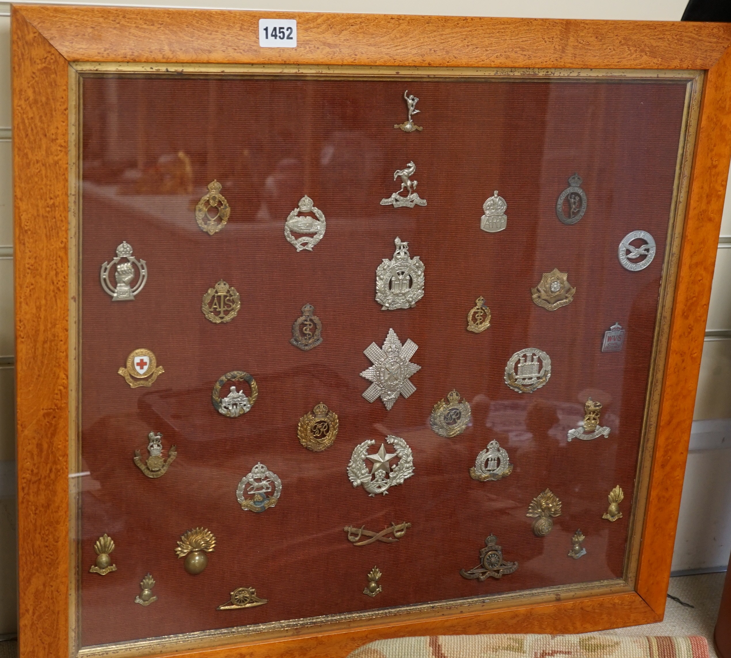 A framed collection of military cap Badges                                                                                                                                                                                  