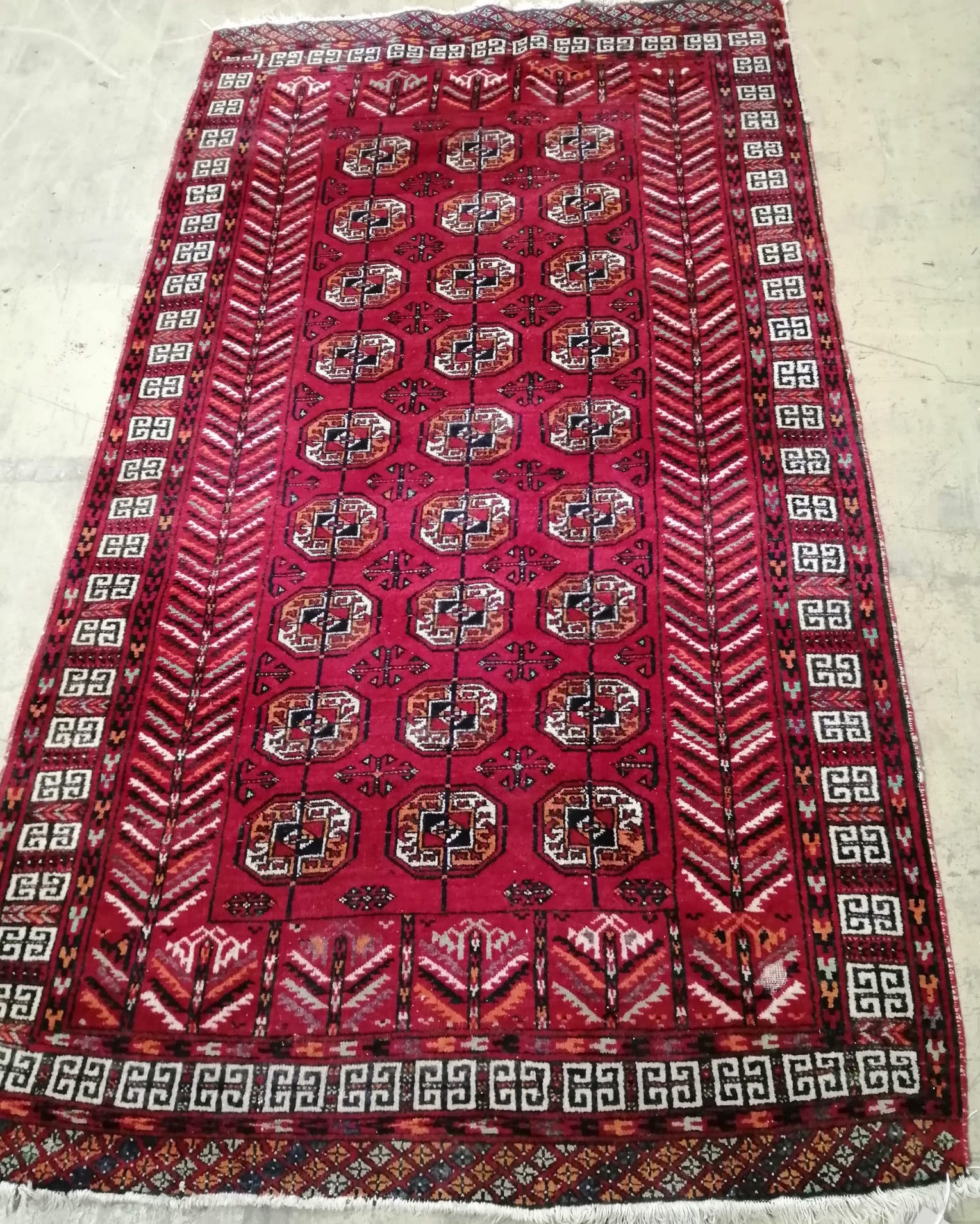 A Bokhara red ground rug, 202 x 116cm                                                                                                                                                                                       
