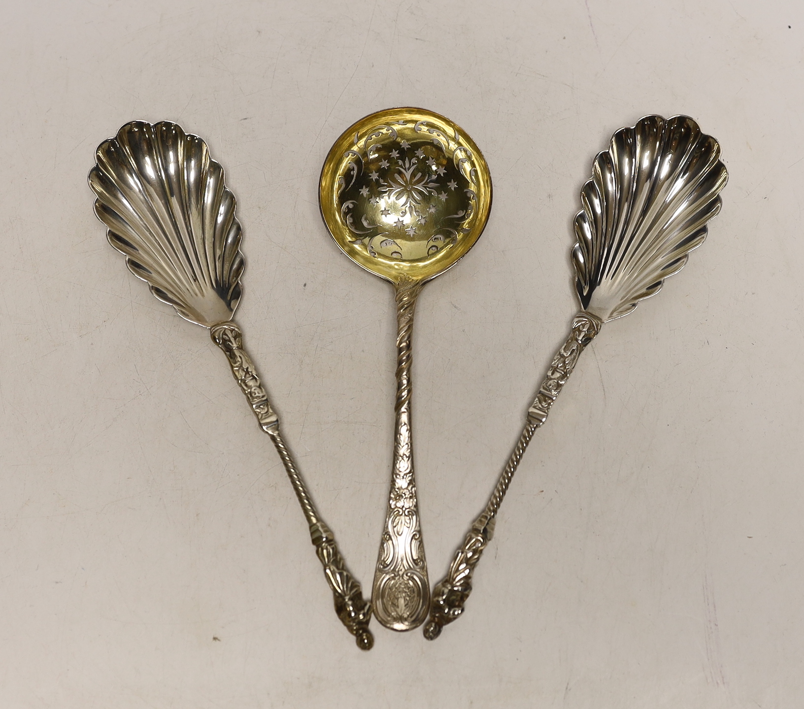 A pair of Victorian silver apostle serving spoons, Edward Hutton, London, 1890, 20.5cm and a George III silver sifter spoon, London, 1761.                                                                                  