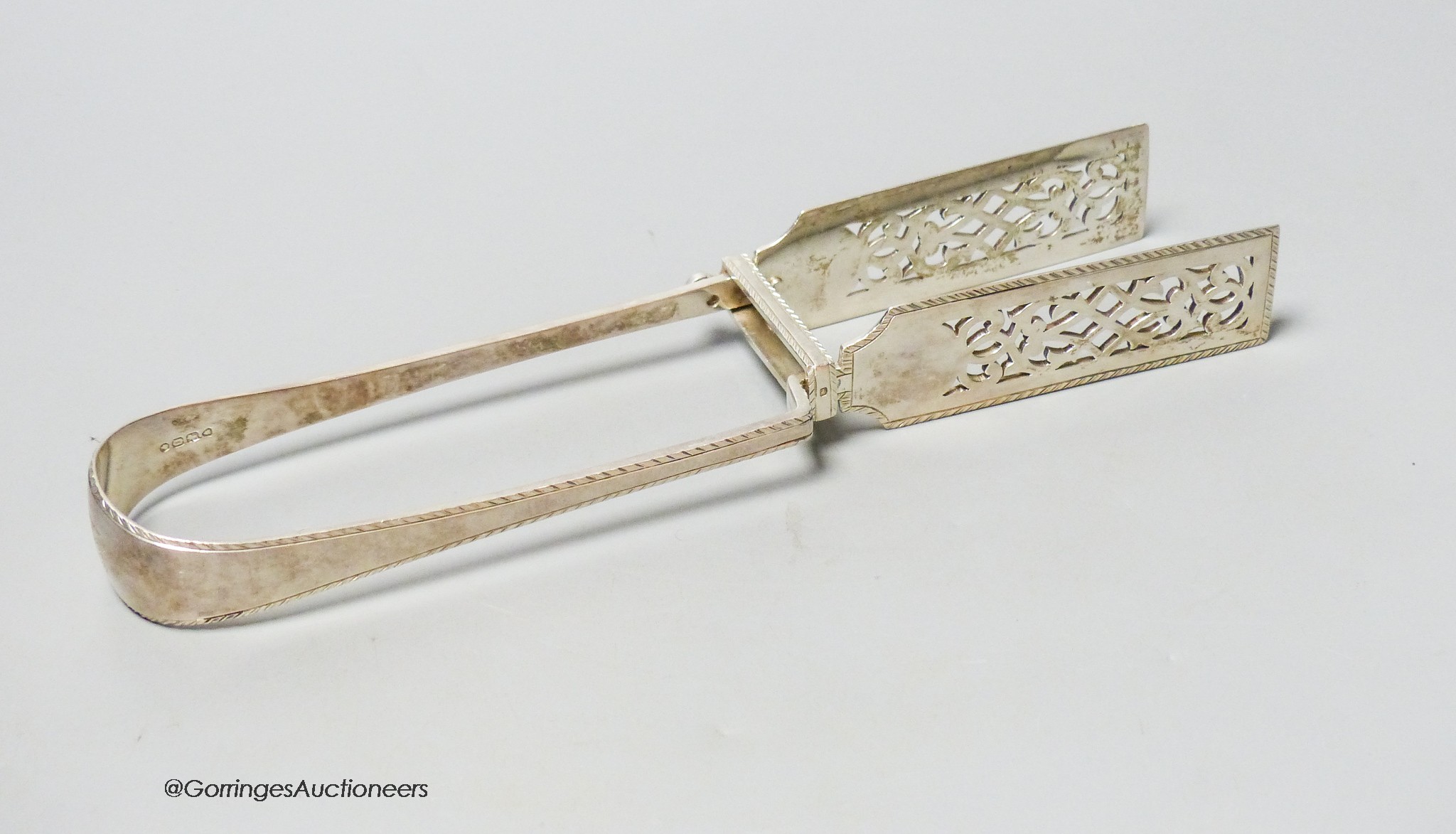 A pair of Victorian silver engraved feather edge asparagus tongs, by George Adams, London, 1869, 25.1cm, 6.5oz.                                                                                                             