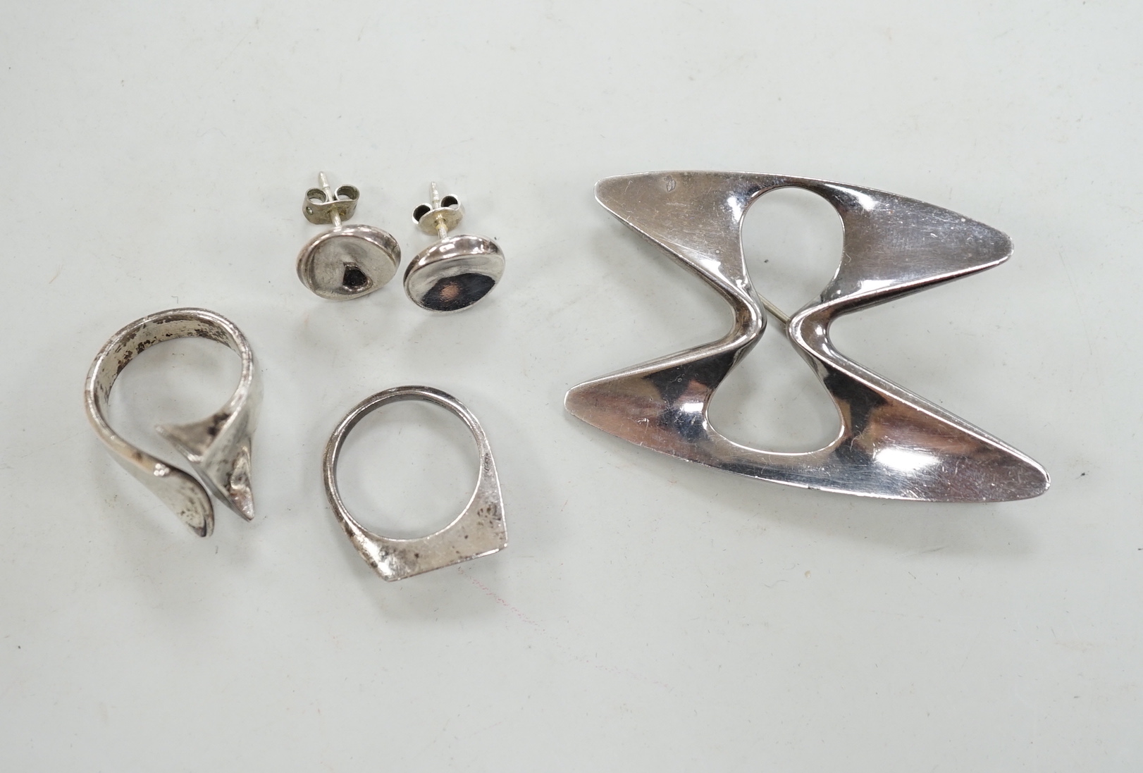 A Georg Jensen sterling free form brooch, design no. 369, a pair of Georg Jensen ear studs and two white metal rings.                                                                                                       
