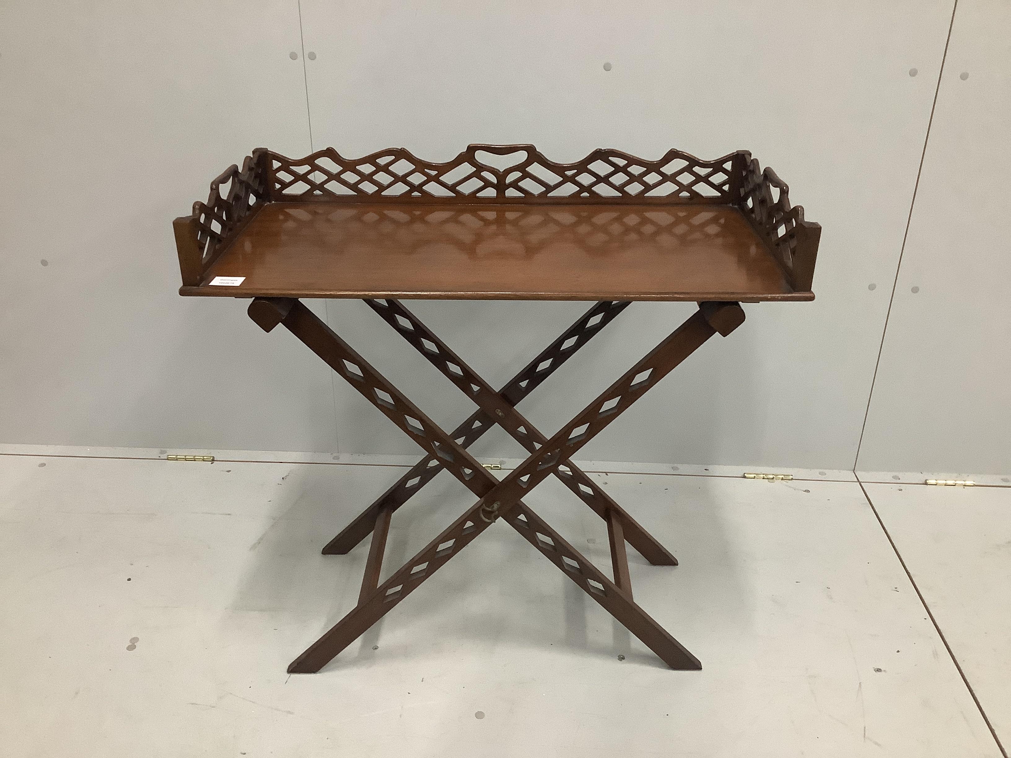 A reproduction George III style mahogany butler's tray on folding stand, width 84cm, depth 41cm, height 82cm                                                                                                                