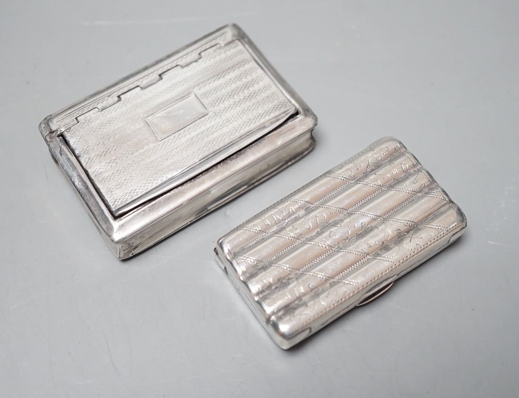 A George IV engine turned silver rectangular snuff box, Lawrence & Co, Birmingham, 1824, 59mm and an earlier ribbed silver snuff box by Thropp & Taylor, Birmingham, 1811, both a.f.                                        