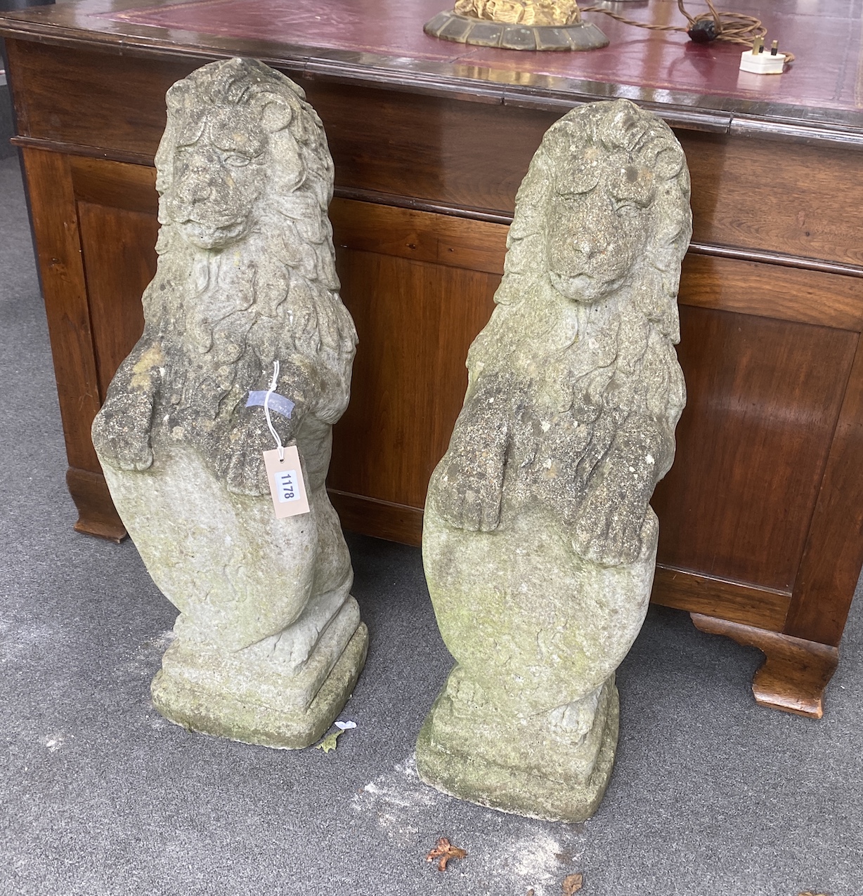 A pair of reconstituted stone heraldic lions, height 80cm                                                                                                                                                                   