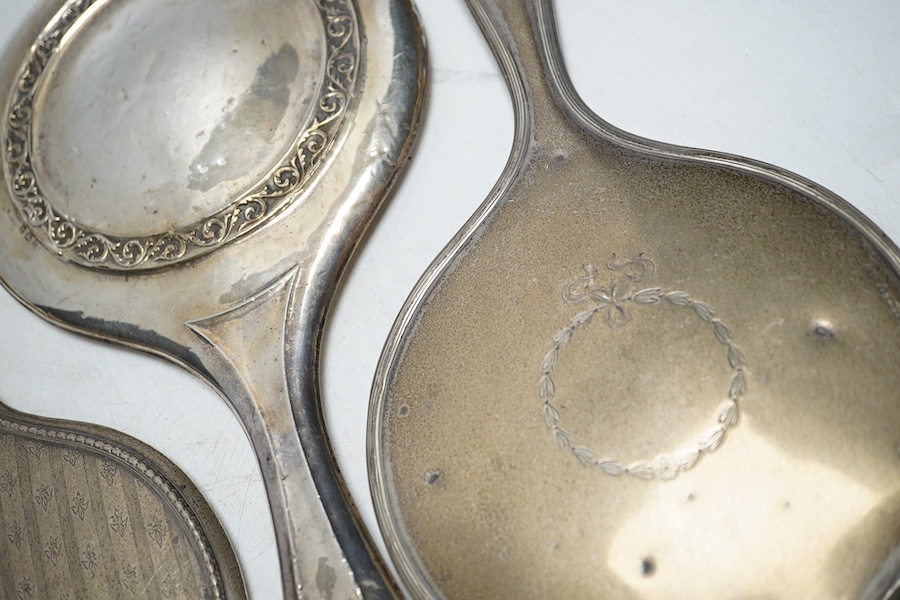 Four assorted silver mounted hand mirrors including London, 1907. Condition - poor to fair                                                                                                                                  