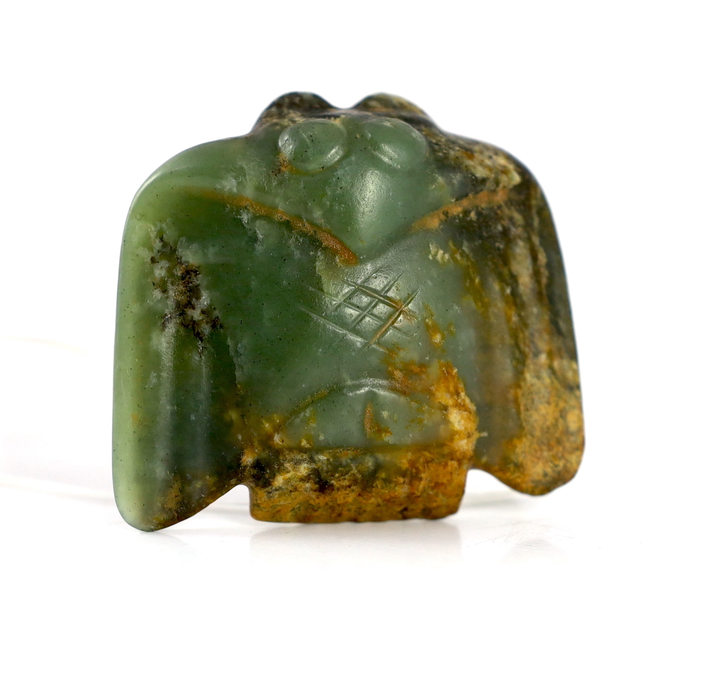 A Chinese archaic green and russet jade carving of a bat or bird, 5.5 cm wide                                                                                                                                               