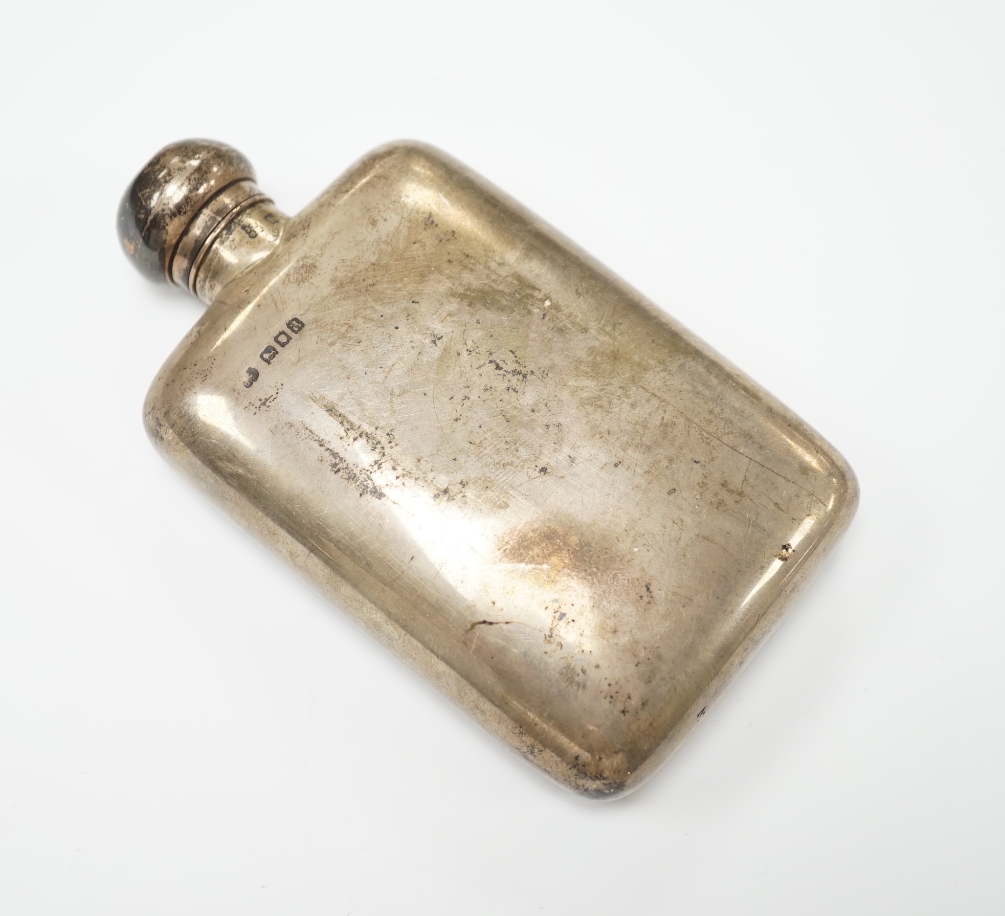 A George V silver hip flask, Neal & Neal, London, 1916, 12.8cm.                                                                                                                                                             