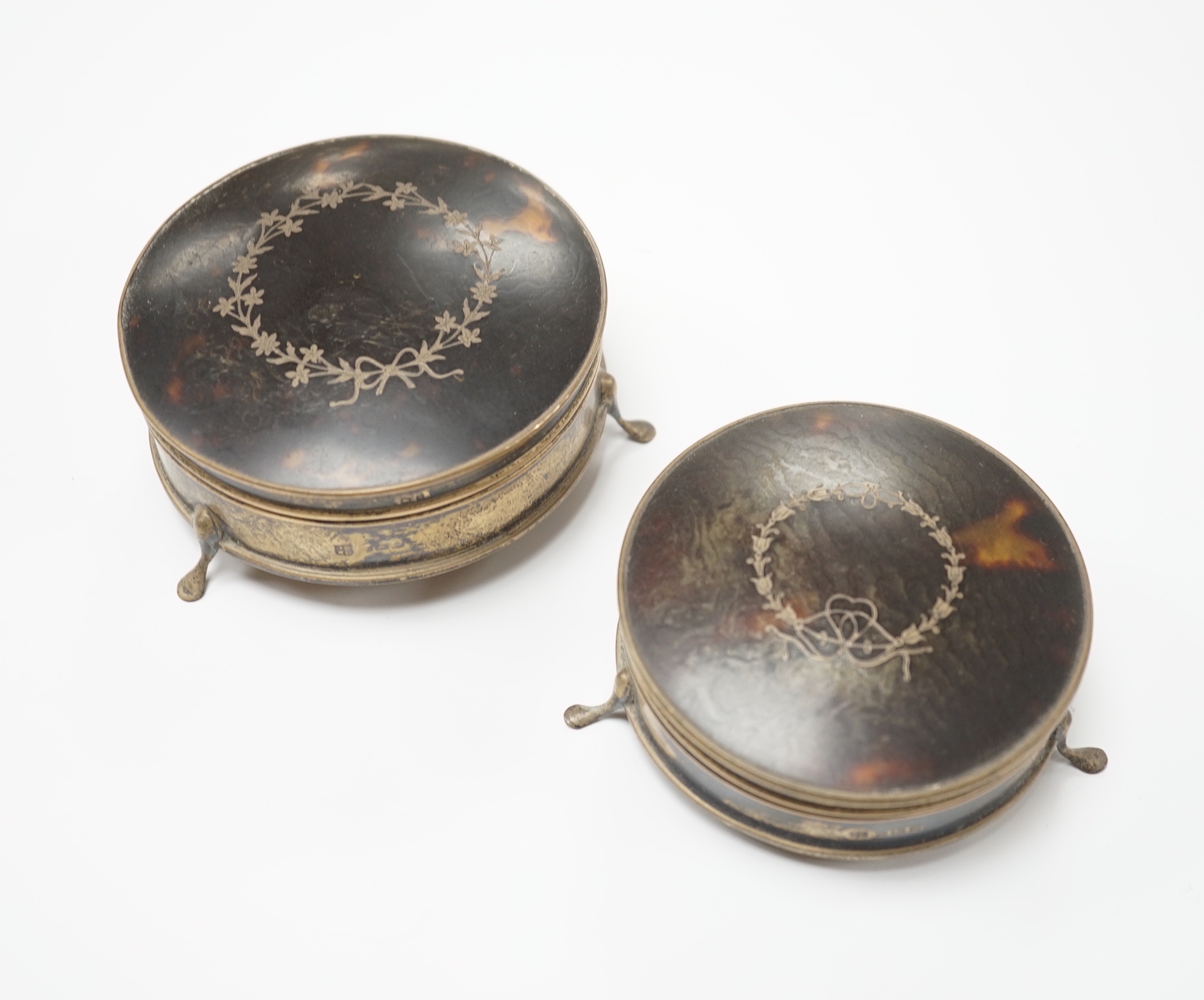Two George V silver and tortoiseshell pique mounted circular trinket boxes by James Deakin & Sons, Birmingham, 1921, largest diameter 9cm.                                                                                  