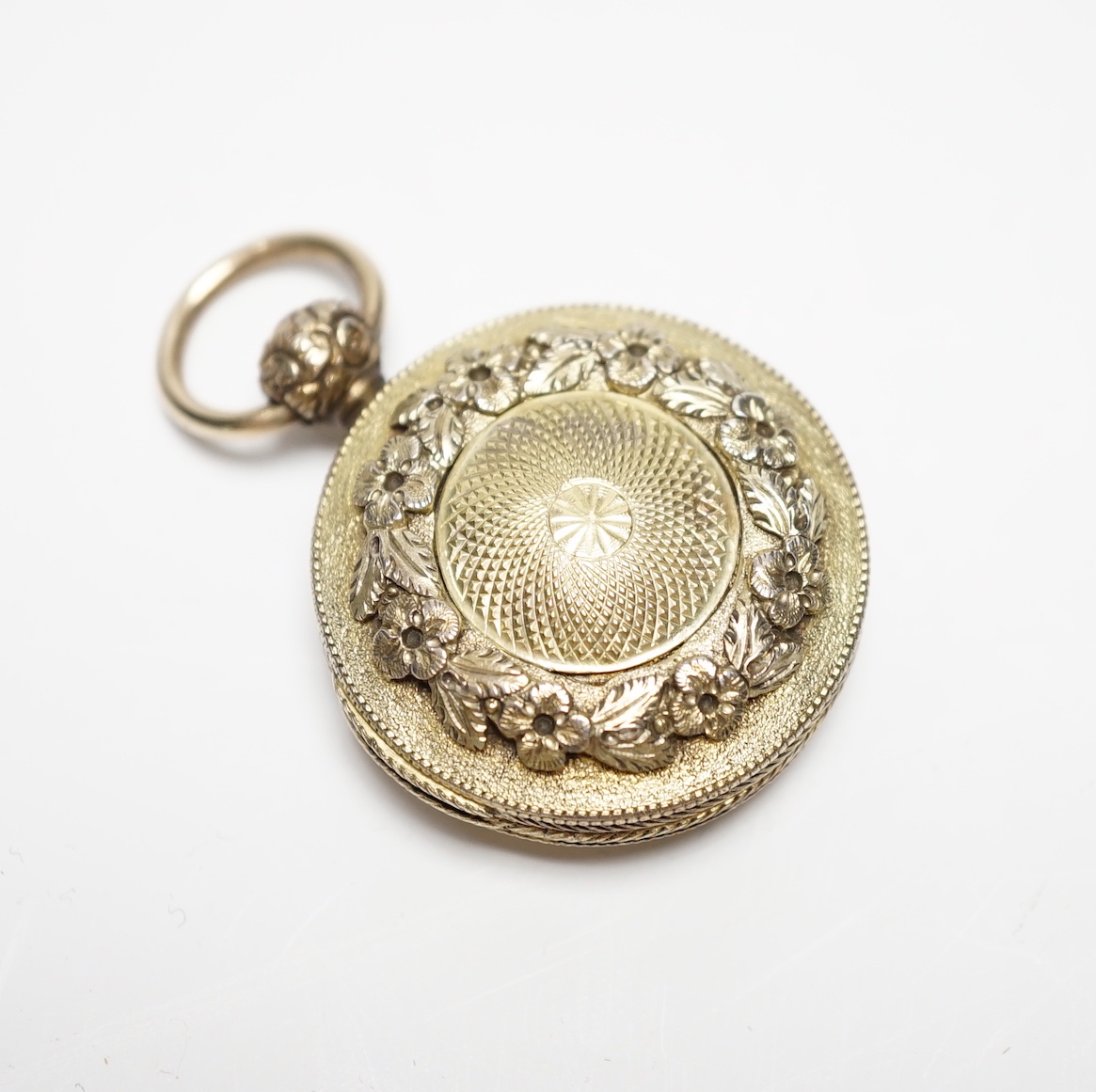 A George III engine turned two colour silver gilt circular vinaigrette, maker, GW, both sides with milled edges and foliate band, London, 1819, 33mm, (repair).                                                             
